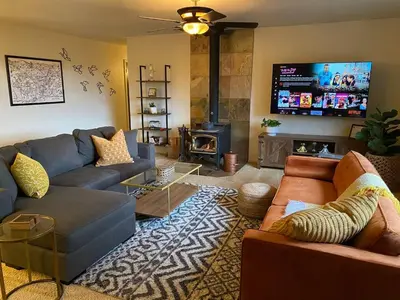 a living room with two couches and a tv at Cozy Cabin Near Yosemite & Bass lake, Breathtaking Views & Private Hot Tub, BBQ, Nature Getaway in Oakhurst