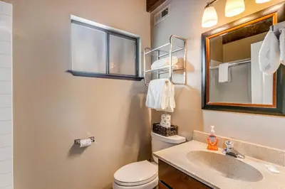 a bathroom with a toilet and a sink and a mirror at Fairway Forest in Incline Village