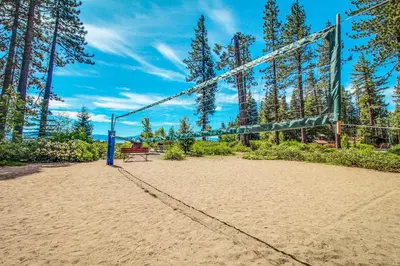 a volleyball court with a bench and a net at Talmont Trailhead Cabin in Tahoe City