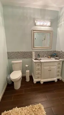 a bathroom with a toilet and a sink and a mirror at Beautiful peaceful desirable home in Madera Rancho in Madera