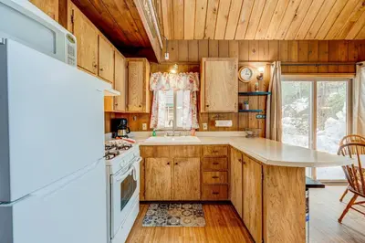 a kitchen with wooden cabinets and a stove top oven at Lofty Lodi in South Lake Tahoe