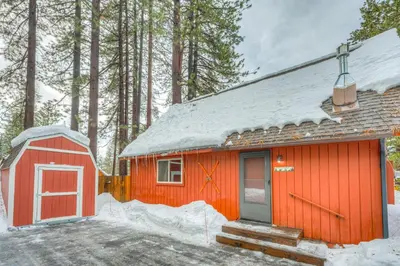 a red cabin with a snow covered roof at Lofty Lodi in South Lake Tahoe