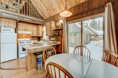 a kitchen and dining room with a table and chairs at Lofty Lodi in South Lake Tahoe