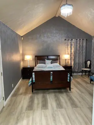 a bedroom with a bed and two lamps on tables at Beautiful peaceful desirable home in Madera Rancho in Madera