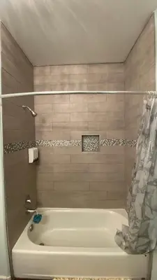 a white bath tub in a bathroom with a shower at Beautiful peaceful desirable home in Madera Rancho in Madera