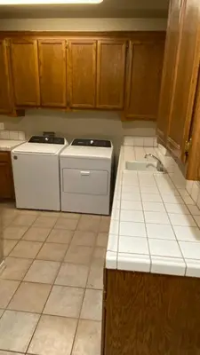 a kitchen with white appliances and wooden cabinets at Beautiful peaceful desirable home in Madera Rancho in Madera