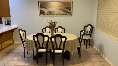 a dining room with a table and six chairs at Beautiful peaceful desirable home in Madera Rancho in Madera