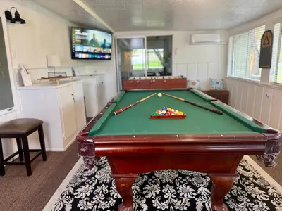 a pool table in a living room with a pool table at The Happy Cabin w/ hot tub in Oakhurst