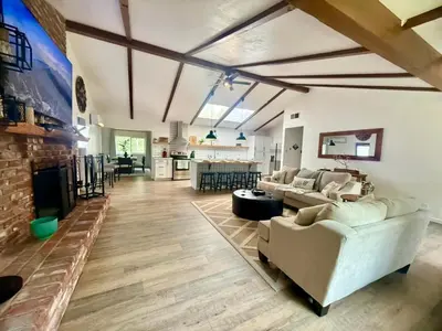 a living room with a couch and a fireplace at The Happy Cabin w/ hot tub in Oakhurst