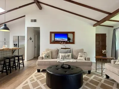 a living room with a couch and a table at The Happy Cabin w/ hot tub in Oakhurst