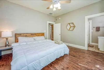 a bedroom with a large bed and a ceiling fan at 2 King Beds! Fantastic Stylish Bungalow home! in Fresno