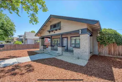 a house with a fence in front of it at 2 King Beds! Fantastic Stylish Bungalow home! in Fresno