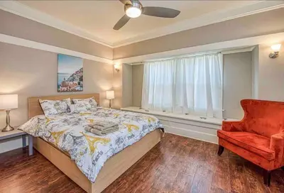 a bedroom with a bed and a chair and a window at 2 King Beds! Fantastic Stylish Bungalow home! in Fresno
