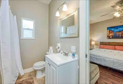 a bathroom with a sink and a toilet and a bed at 2 King Beds! Fantastic Stylish Bungalow home! in Fresno