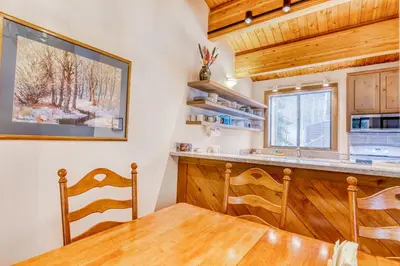 a kitchen with a table and chairs and a window at Evergreen Escape in Truckee