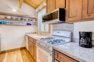 a kitchen with a stove and a microwave at Evergreen Escape in Truckee