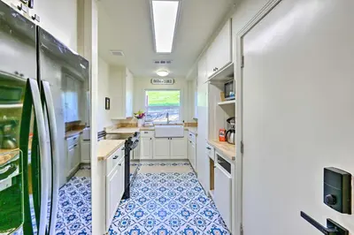 an rv kitchen with a blue and white tile floor at Peaceful Ranch Home with Sierra Nevada Views in Woodlake