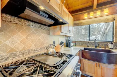 a kitchen with a stove top oven next to a sink at Rocky Revival in Truckee