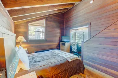 a bedroom with wooden walls and a bed in a room at Rocky Revival in Truckee