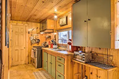 a kitchen with wooden cabinets and a sink at California Retreat with Deck, Fire Pit and Grill! in Long Barn