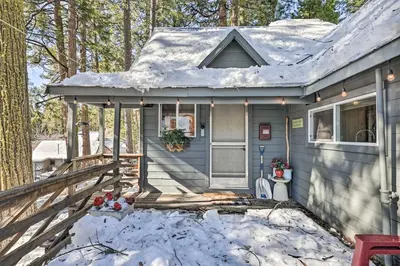 a small blue house with snow on the roof at California Retreat with Deck, Fire Pit and Grill! in Long Barn