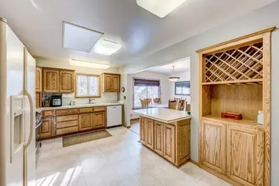 a large kitchen with wooden cabinets and a refrigerator at Lakeview Serenity in Incline Village