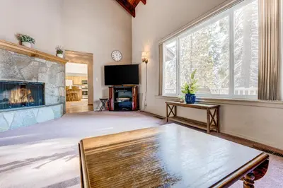 a living room with a fireplace and a tv at Lakeview Serenity in Incline Village