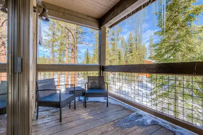 a screened porch with chairs and a view of trees at Silver Strike Serenity in Truckee