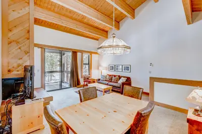 a living room with a wooden table and a couch at Silver Strike Serenity in Truckee
