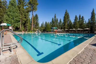 a large swimming pool with trees in the background at Silver Strike Serenity in Truckee