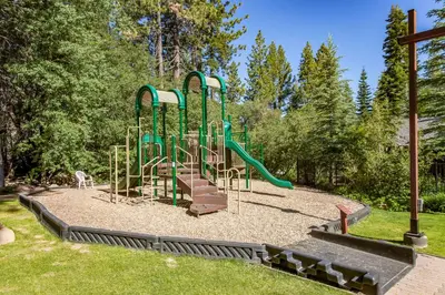 a playground with a slide in a park at Silver Strike Serenity in Truckee