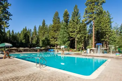 a swimming pool in a resort with trees at Silver Strike Serenity in Truckee