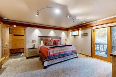 a bedroom with a bed in a room with a window at A Slice of Silver Fir in Truckee