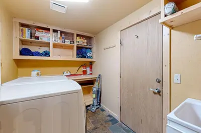 a laundry room with a washing machine and a sink at A Slice of Silver Fir in Truckee