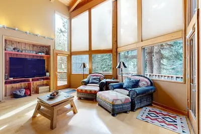 a living room with two couches and a tv at A Slice of Silver Fir in Truckee