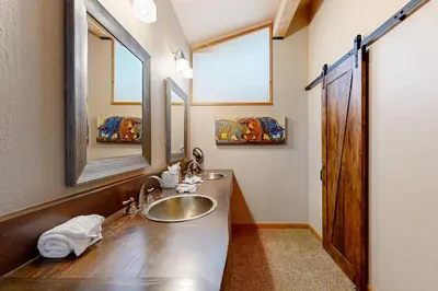 a bathroom with a sink and a mirror at A Slice of Silver Fir in Truckee