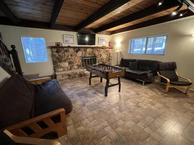 a living room with a couch and a fireplace at Close To Heaven With Hot Tub, Wet Bar & Game Room in South Lake Tahoe