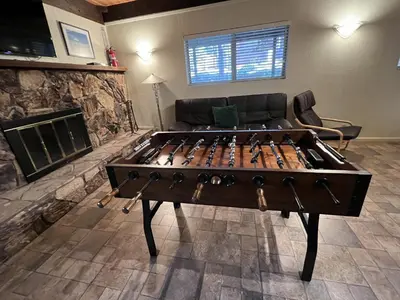 a large wooden game table in a living room at Close To Heaven With Hot Tub, Wet Bar & Game Room in South Lake Tahoe