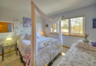 a bedroom with a canopy bed and a window at Enviable Lake & Mountain Views Wth Waterfall in South Lake Tahoe