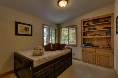 a bedroom with a bed and a large window at Brand New Upscale Home, Hot Tub, Foosball in South Lake Tahoe