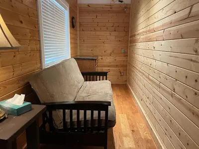 a room with a chair and a table in a wooden room at Newly Renovated, Foosball Table in South Lake Tahoe