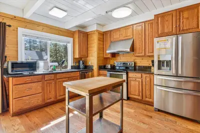 a kitchen with wooden cabinets and stainless steel appliances at Newly Renovated, Foosball Table in South Lake Tahoe