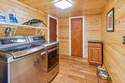a kitchen with a stove and a wooden wall at Newly Renovated, Foosball Table in South Lake Tahoe