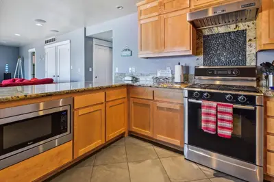 a kitchen with wooden cabinets and a stove top oven at Private Beach, Close To Everything in South Lake Tahoe