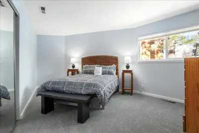 a bedroom with a bed and a window at Private Beach, Close To Everything in South Lake Tahoe