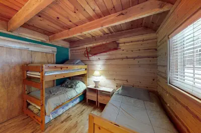 a bedroom with two bunk beds in a log cabin at Walkup Pines in South Lake Tahoe