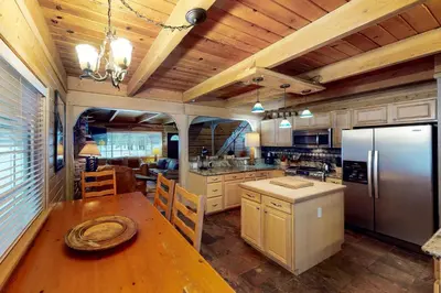 a kitchen with a table and a refrigerator at Walkup Pines in South Lake Tahoe