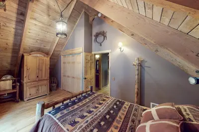a bedroom with a bed and a wooden ceiling at Walkup Pines in South Lake Tahoe