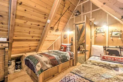 two beds in a room with wooden walls at 8 Mi to Heavenly Mtn Resort! Hot Tub Hideaway in South Lake Tahoe