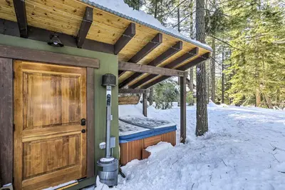 a house with a wooden door in the snow at 8 Mi to Heavenly Mtn Resort! Hot Tub Hideaway in South Lake Tahoe
